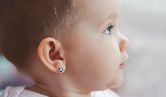 Fotografía de un bebé con un pendiete